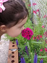 Close-up of girl with pink flowering plants