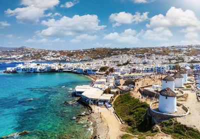 High angle view of buildings by sea against sky