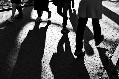 Low section of people standing on footpath