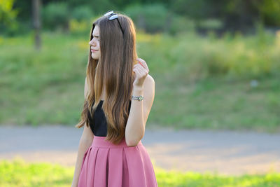 Side view of young woman standing outdoors