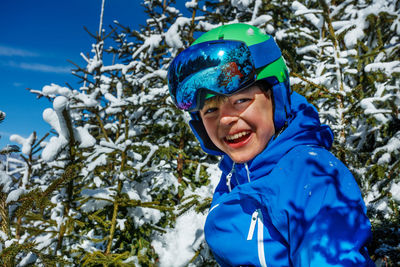 Portrait of young man skiing on snow