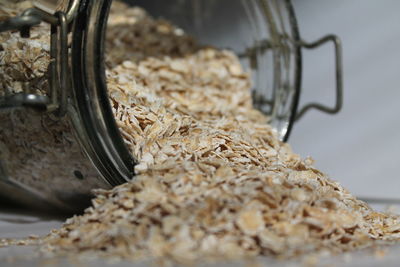Close-up of oat flake coming out from glass jar at home
