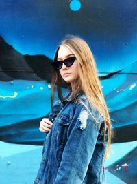 Young woman wearing sunglasses standing outdoors