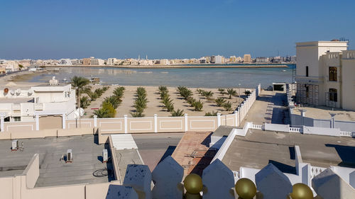 High angle view of swimming pool by buildings against sky