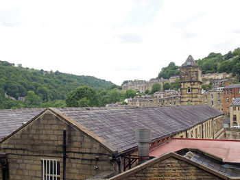 Buildings against cloudy sky