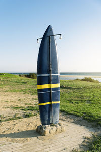 View of wooden posts on beach against clear sky