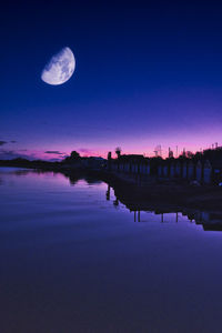 Scenic view of lake against sky at night