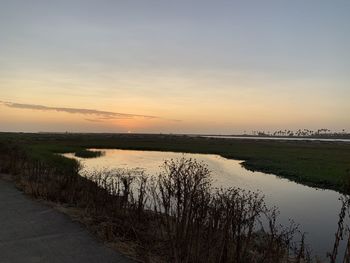 Scenic view of lake against sky during sunset