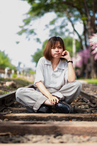 Portrait of young woman sitting outdoors