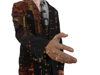 Digital composite image of hand holding umbrella against white background