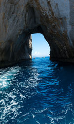 Scenic view of sea seen through cave