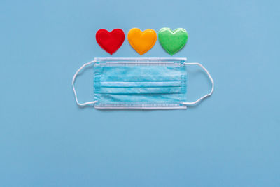 High angle view of heart shape on table against blue background