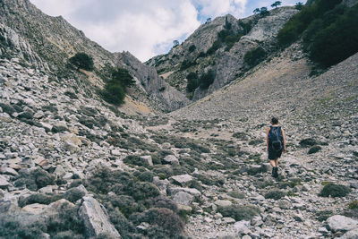 Woman hiking on a mountain path in catalonia on a cloudy summer day