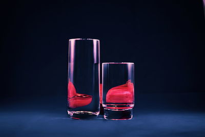 Close-up of wineglass against black background