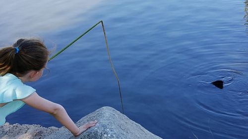 Girl fishing in lake