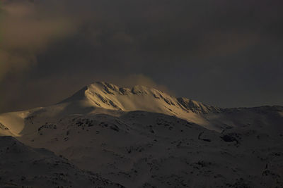 Scenic view of snow covered mountains against sky