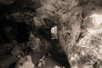 Rock formations in sea seen through cave