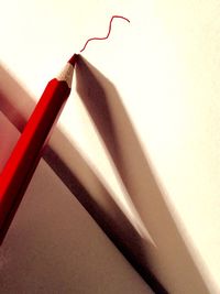 Red pencil on wall