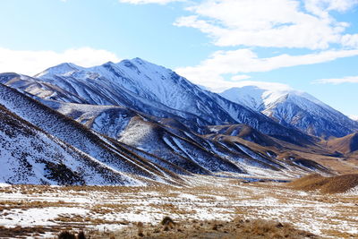 Scenic view of snowcapped mountains against sky