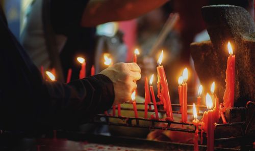 Close-up of lit candles in temple