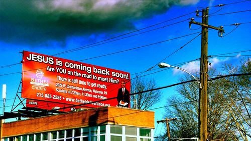 Low angle view of power lines against sky