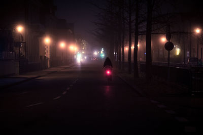 Illuminated city street at night