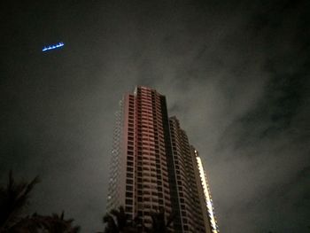 Low angle view of skyscrapers against sky at night