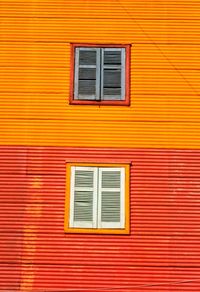Shuttered windows of orange building