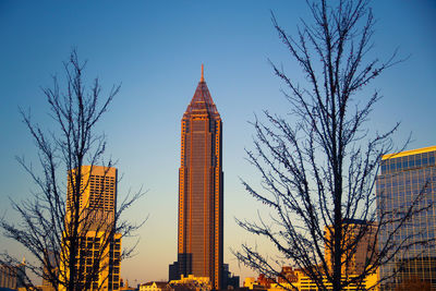 Low angle view of tall buildings against blue sky