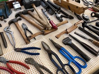 High angle view of tools on table in workshop