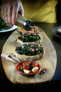 Close-up of hand holding pizza