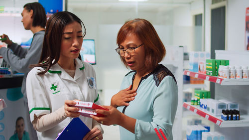 Female friends using digital tablet in laboratory