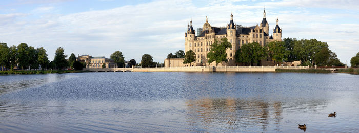 Panoramic view of river and buildings against sky