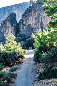 Road amidst rocks against mountains