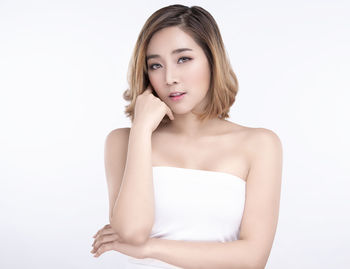 Portrait of a beautiful young woman over white background