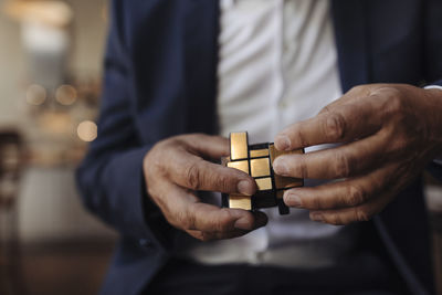 Close-up of businessman with rubik's cube
