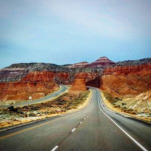 Empty road leading towards mountains