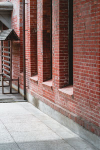 View of red brick wall with building