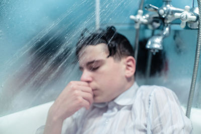 Close-up of man in bathtub