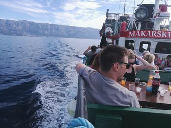 Man photographing sea against sky