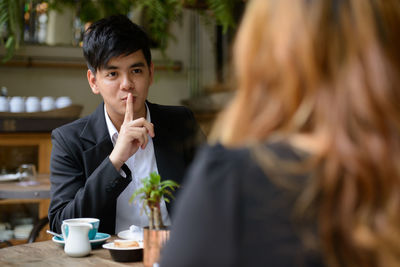 Portrait of young man with coffee cup