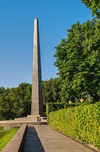 People walking in park against sky