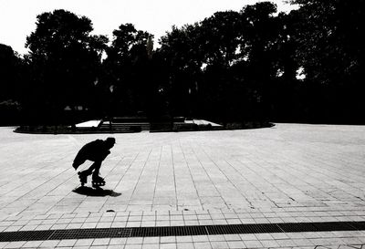 Silhouette man against trees