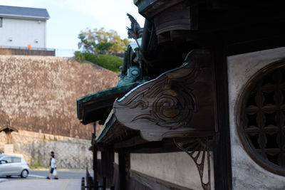 Close-up of statue against built structure