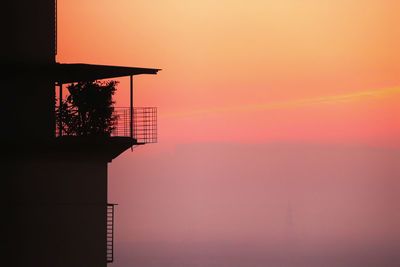 Silhouette building against sky during sunset