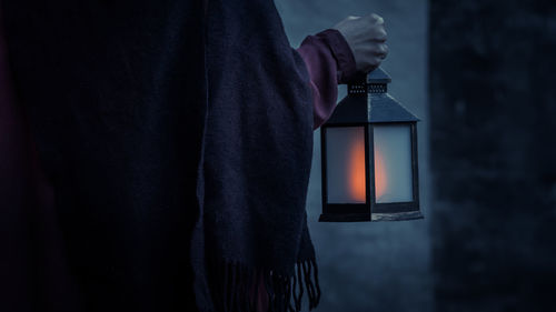 Close-up of hand holding an illuminated light lantern