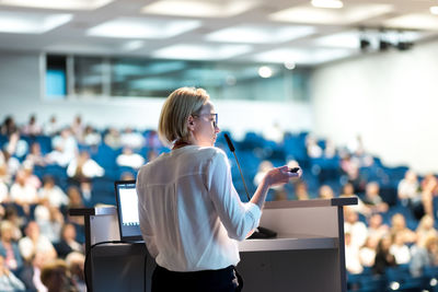 Rear view of woman using mobile phone