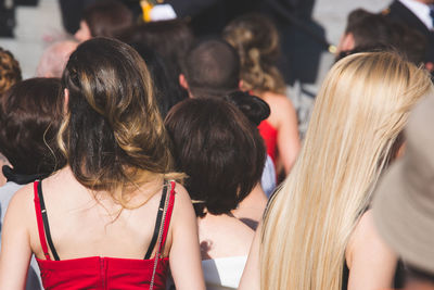 Rear view of woman enjoying music concert