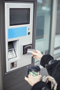 Woman using card to withdraw money from atm