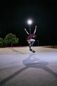 Young white man jumping on his skateboard